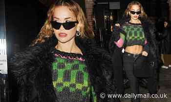 Rita Ora flashes her toned abs in a green crop top and black jeans