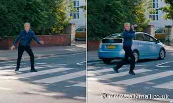 Sir Paul McCartney waves arms in air after he was nearly HIT by a car