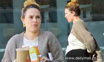 Rumer Willis flashes her growing baby bump in black leggings as she picks up five smoothies