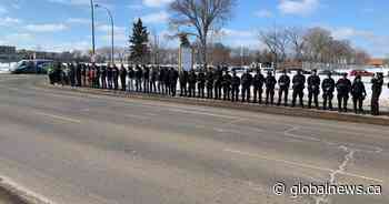 Edmontonians show support as bodies of slain police officers transported to funeral home
