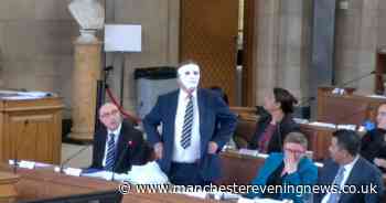 Bizarre moment Manchester councillor puts on faceless MASK during debate... leaving leader with her head in her hands
