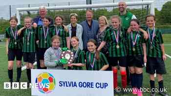 Schoolgirls who came together for Sylvia Gore Cup take home trophy