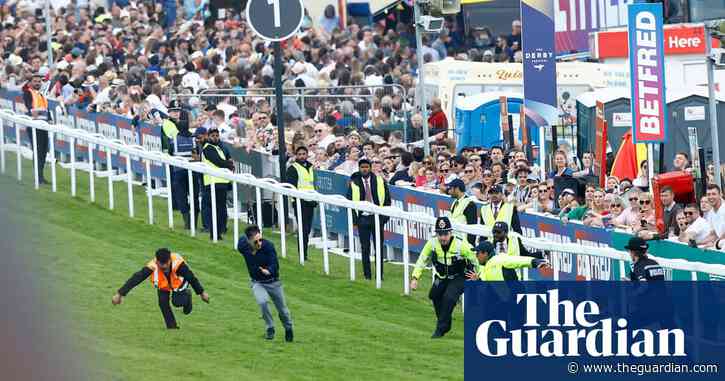 Police detain protester for running on track during Derby at Epsom