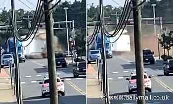 Moment tractor-trailer stuck on a railroad is smashed to pieces by oncoming train in North Carolina