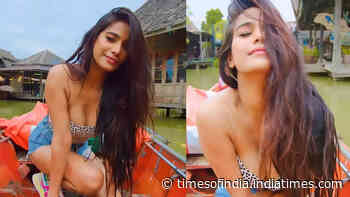 Poonam Pandey flaunts her glamorous look in a black dotted crop top and denim shorts while enjoying a boat ride