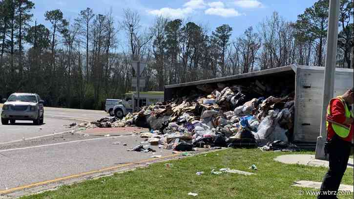 Load of trash scattered on Walker roundabout after truck overturns