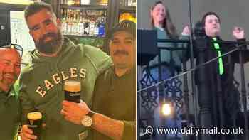 Jason Kelce enjoys his retirement as he sinks Guinness at an Irish bar on St Patrick's Day weekend... while wife Kylie takes the spotlight by dancing on a balcony in front of hundreds of fans!
