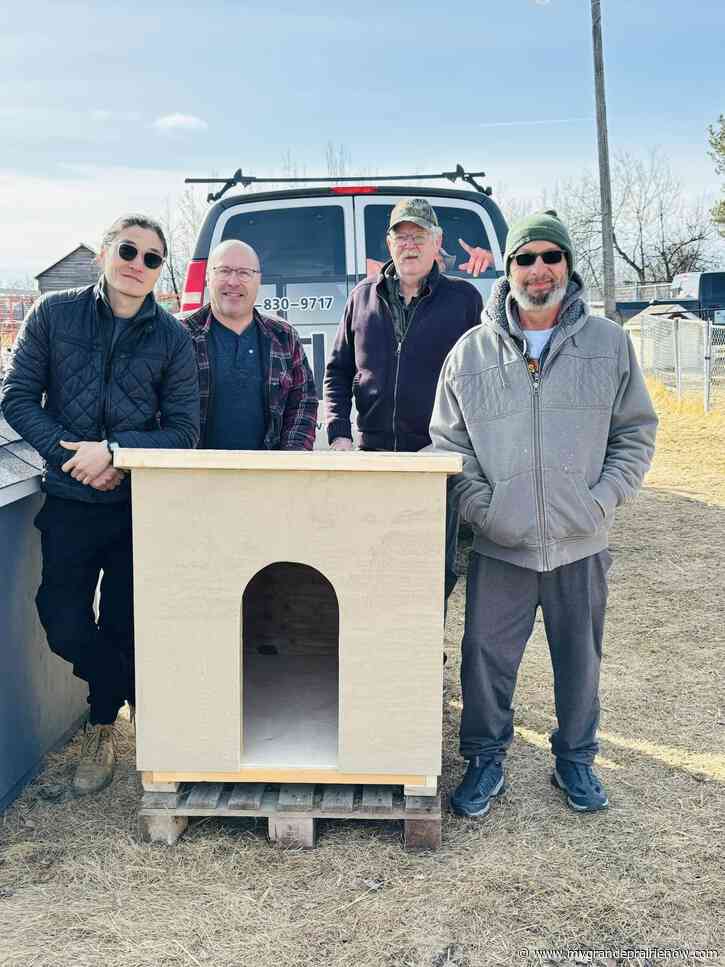 Local men’s group donates hand-crafted doghouse to Tsintah husky shelter