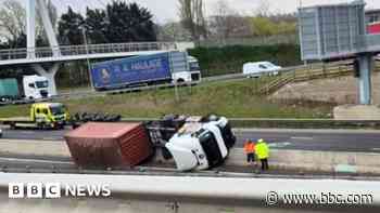 A14 shut in both directions after lorry overturns