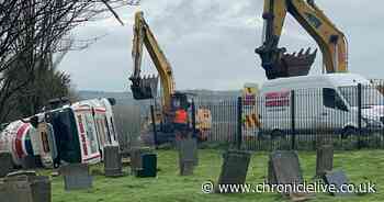 See moment overturned concrete lorry recovered after crashing through railings of Gateshead cemetery