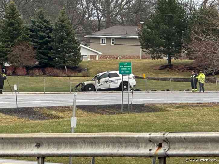 Officer hospitalized after police vehicle crashes into tractor-trailer, catches fire