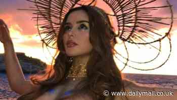 Demi Rose puts on a very busty display as she poses TOPLESS with just gold body paint to retain her modesty for a slew of jaw-dropping snaps
