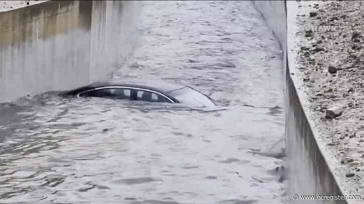 Car underwater in flood control channel in Fullerton as storm drenches ...