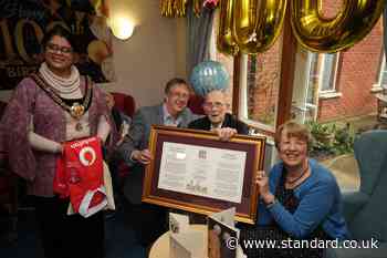 Wartime hero who saved famed building grins as he is honoured on 100th birthday