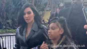 Kim Kardashian and her mini-me daughter North West, 10, match in black as they arrive at the Lakers game in Los Angeles