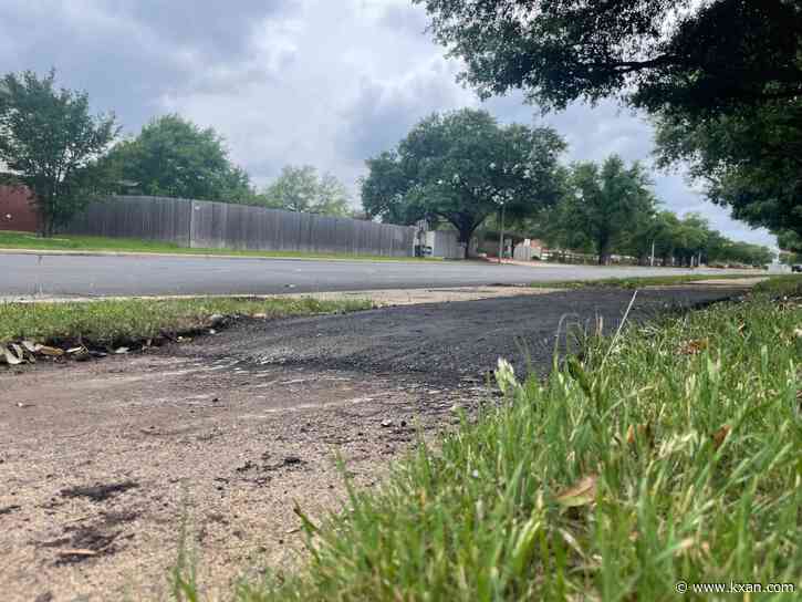 Why do some Austin neighborhoods have black asphalt on sidewalks?