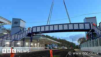 Railway station bridge lowered into place