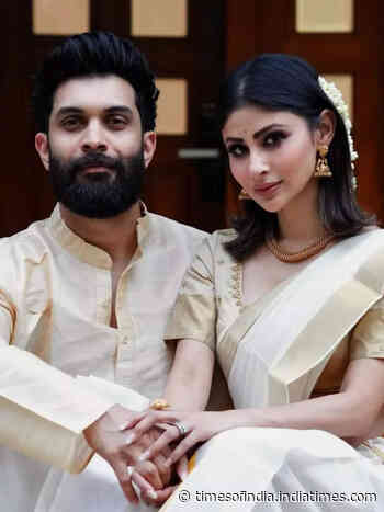 Mouni poses with Suraj in a kasavu saree