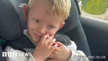 Boy surprised by teddy bear with hearing aids