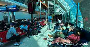 Families forced to sleep on airport floor as flights are cancelled due to torrential rain in Dubai