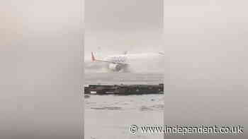 Plane battles through floods at Dubai airport as heavy rain causes cancelled flights