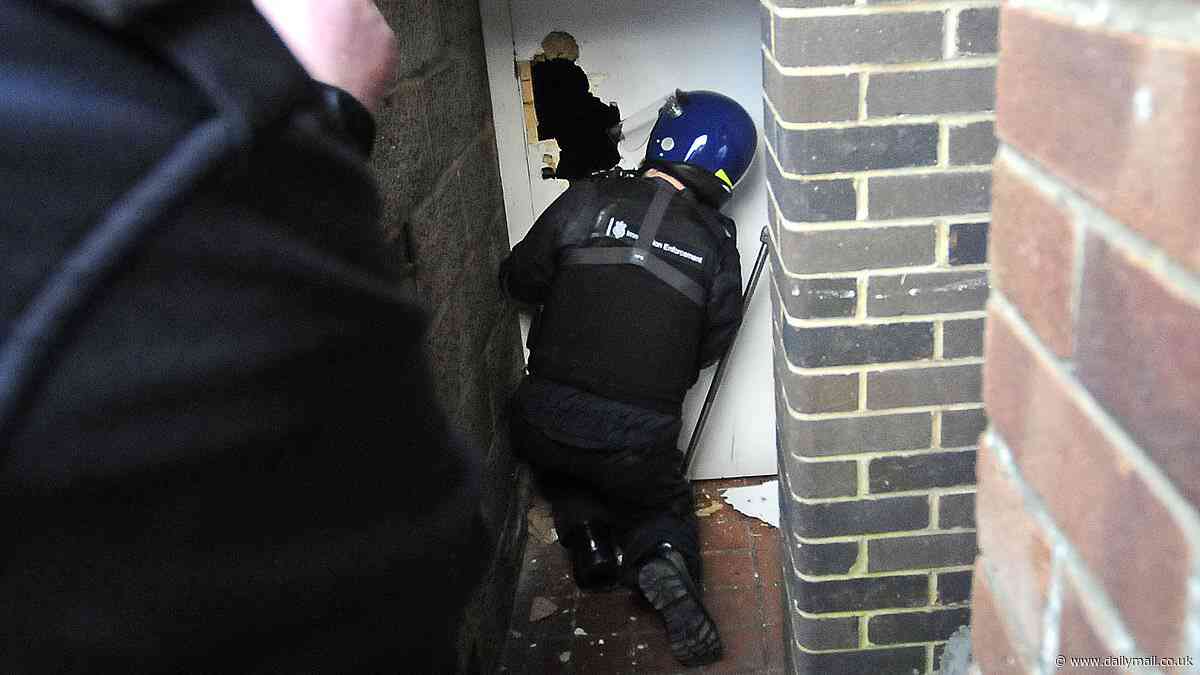 Moment Home Office cops kick down door in dawn raid to smash 'sophisticated' people-smuggling gang who smuggled up to 50 illegal migrants into UK and charged £1,000 a time for fake passports
