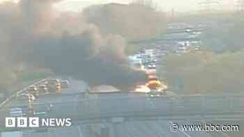 Lorry ablaze on M56 as crews tackle 'thick smoke'