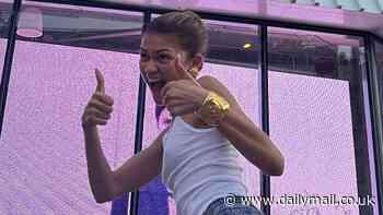 Zendaya gives two thumbs up while striking poses in front of giant billboard for new movie Challengers