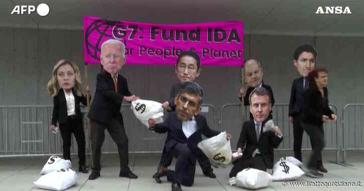 Manifestanti con maschere dei leader de G7 a Washington: la protesta per chiedere fondi per l’Associazione per lo Sviluppo