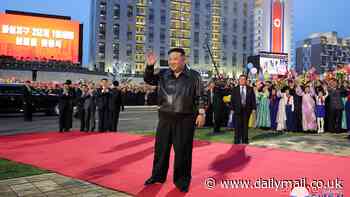 Un size does not fit all: Kim Jong Un wears baggy trousers as he walks the red carpet at ceremony to mark building project