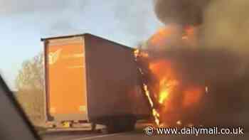 Dramatic moment lorry on the M56 is engulfed by flames: HGV is destroyed by raging inferno - as driver makes a miracle escape from blazing vehicle