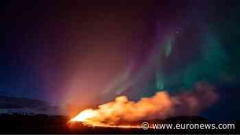 WATCH: Northern Lights shine over an erupting volcano in Iceland