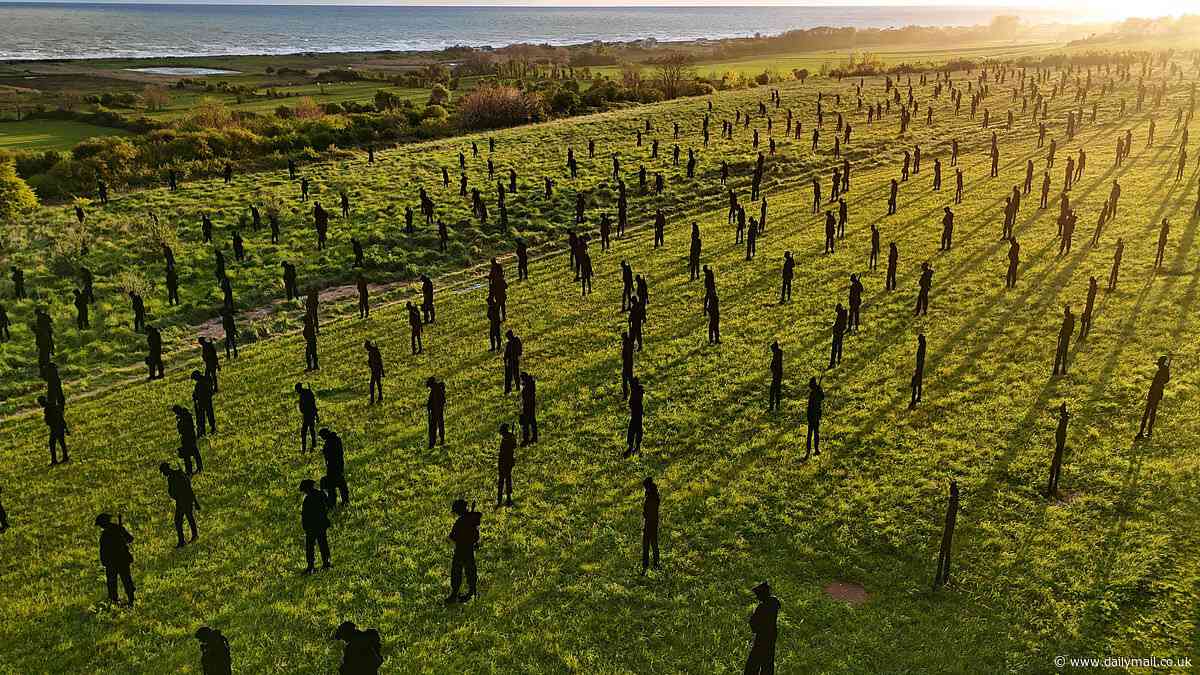 Standing in the shadows of giants: 1,475 statues fill the landscape beside D-Day memorial overlooking France's Gold Beach to honour each of the servicemen who fell during heroic mission