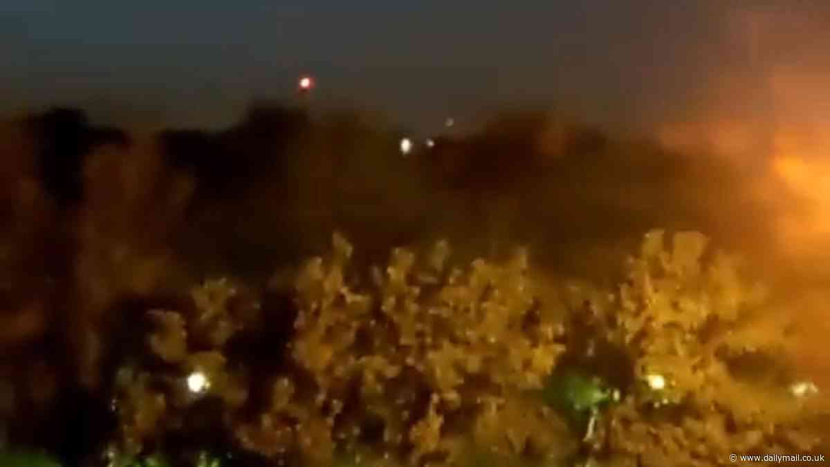 Israel strikes back at Iran: Explosions rock airbase in city linked to Tehran's nuke program but US denies nuclear facilities were targeted after Netanyahu launched attack in defiance of Biden