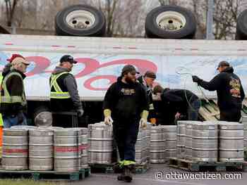 Driver charged after load of beer kegs tumbles off truck in Brockville crash