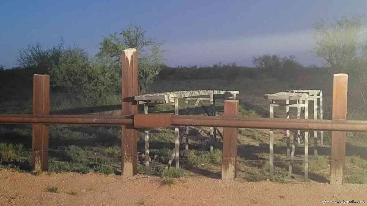 Illegal immigrant smugglers set up a ramp to drive cars over flimsy wooden fence that acts as a 'border wall' on Native American nation in Arizona