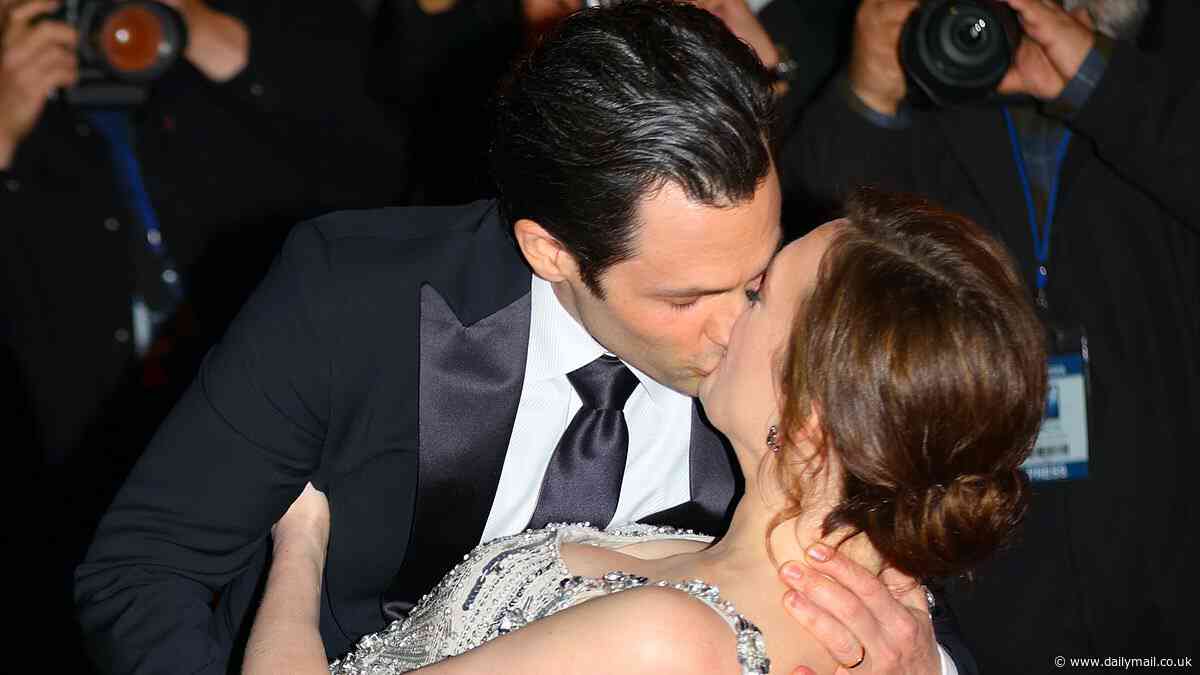 Penn Badgley passionately kisses Charlotte Ritchie on the red carpet as they film a steamy scene for the fifth and FINAL season of You