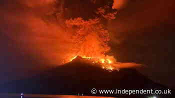 Indonesia: Volcano eruption turns night sky red as lightning stikes around Mount Ruang