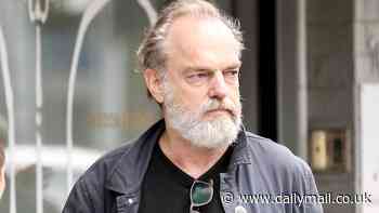 Hugo Weaving keeps it casual as he joins his partner Katrina Greenwood and their friends for a cafe visit in Sydney