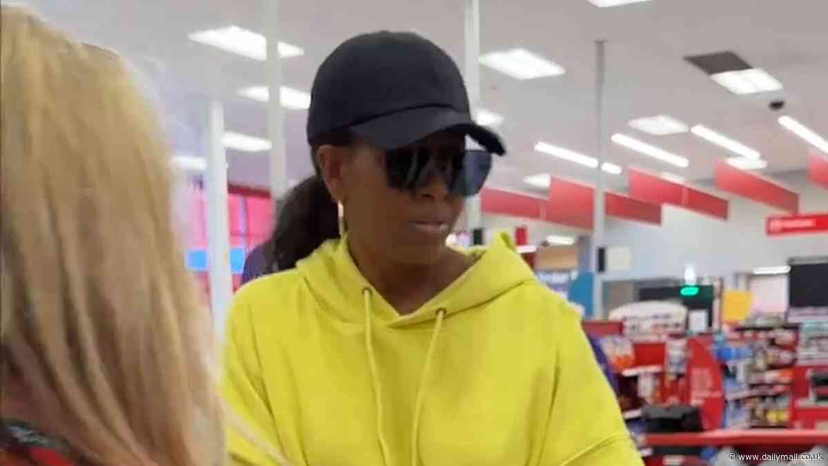 Michelle Obama goes undercover at Target in baseball cap and dark glasses as former first lady reveals secret shopping mission