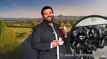 American TV host Adam Richman tries Bury Market's black pudding