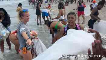 Georgia cops and volunteers clean up Tybee Island beach after raucous spring break partying during the Orange Crush event