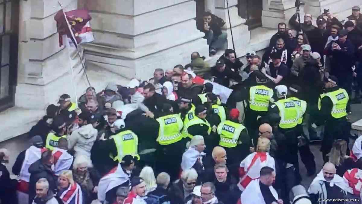 Police clash with St George's Day protesters chanting 'England til I die' near the Cenotaph after far right groups and football hooligans travel from across the UK to mark day