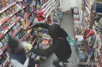 CCTV captures terrifying moment man holds newsagent at gunpoint in armed robbery