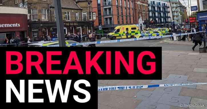 Road taped off by police after reports of incident outside London pub
