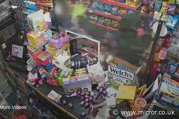 Terrifying moment armed robber points gun and shopkeeper's head before beating him