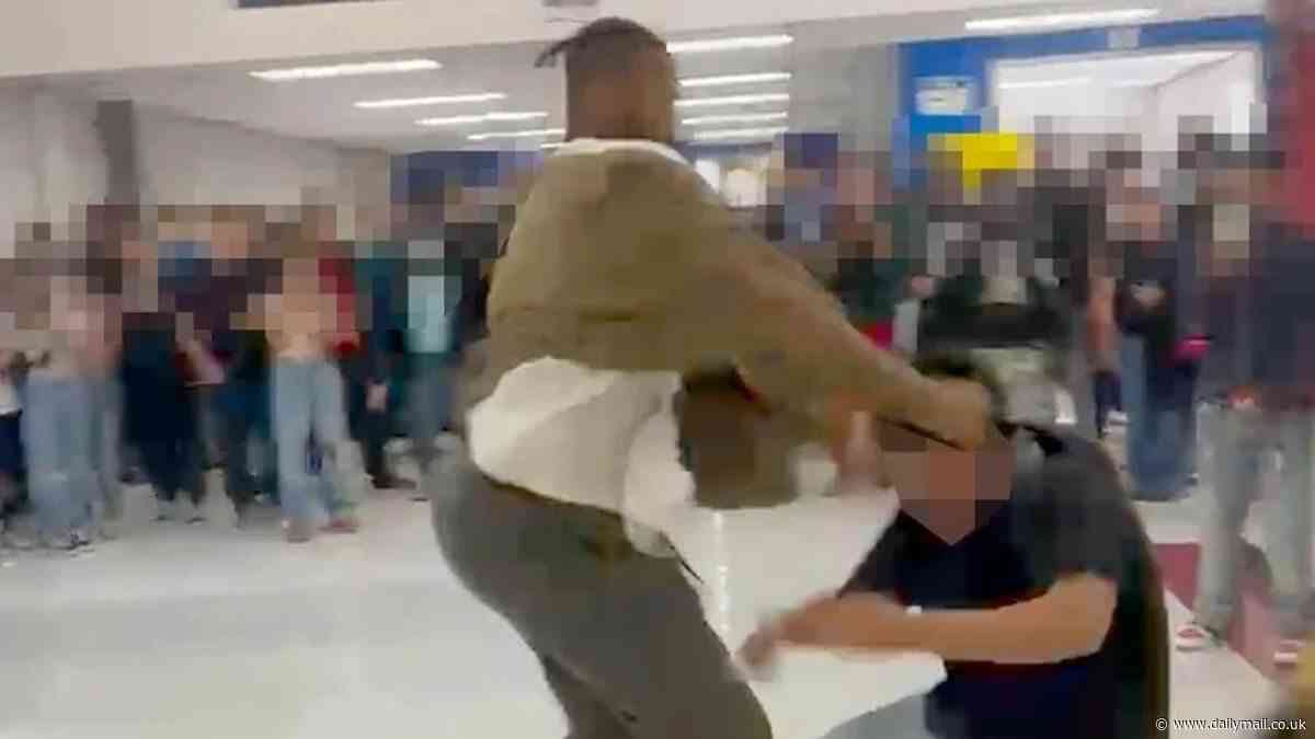Shocking moment Las Vegas substitute teacher, 27, brawls with student 'who called him the n-word' in hallway filled with teenage onlookers