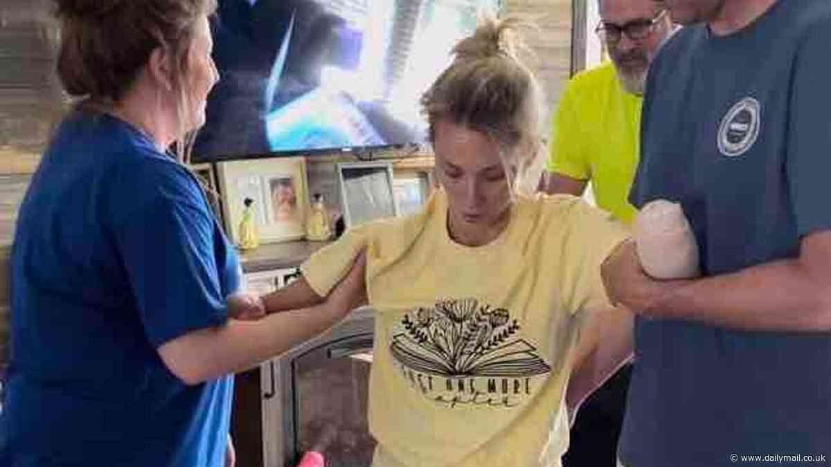 Kentucky nurse who became a quadruple amputee after routine kidney stone surgery led to sepsis WALKS on her new prosthetics for the first time at home