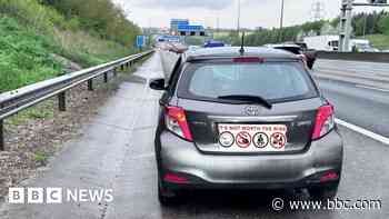 Car stopped on M1 with infants sitting on laps