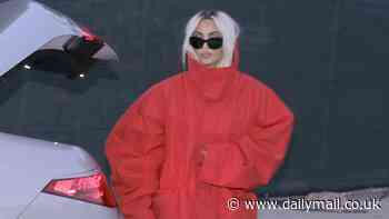 Kim Kardashian dons a stylish oversized red coat and shows off her new blonde locks in Malibu after returning from the White House